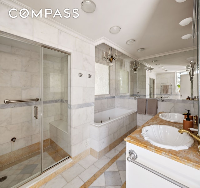 full bathroom featuring crown molding, a shower stall, inlaid floor details, a bath, and vanity