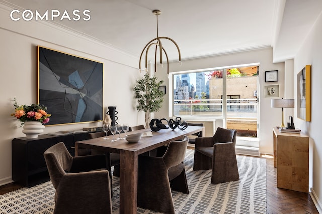 dining room featuring crown molding and baseboards
