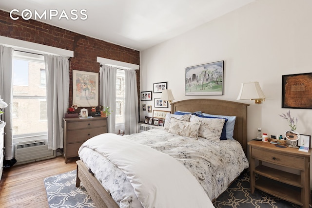 138 W 73rd St, New York City, NY 10023 - bedroom with brick wall and light wood-style flooring