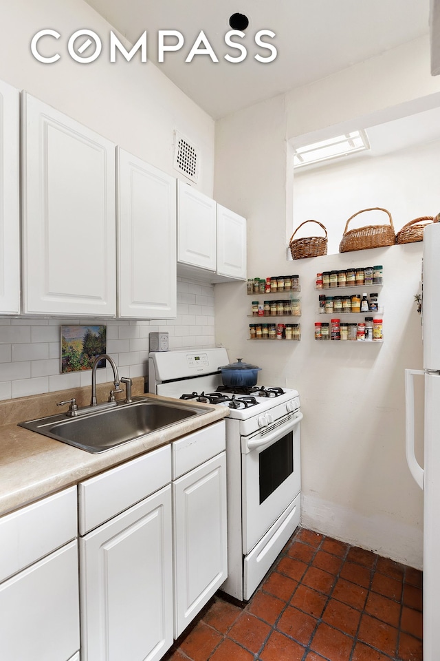 138 W 73rd St, New York City, NY 10023 - kitchen featuring white appliances, a sink, backsplash, and white cabinetry