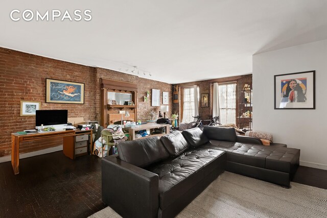 138 W 73rd St, New York City, NY 10023 - living room featuring hardwood / wood-style floors, brick wall, and an office area