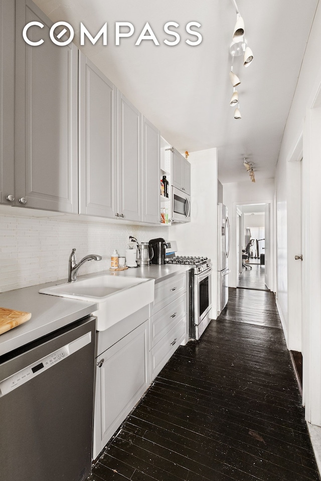 138 W 73rd St, New York City, NY 10023 - kitchen with stainless steel appliances, dark wood-type flooring, tasteful backsplash, and light countertops