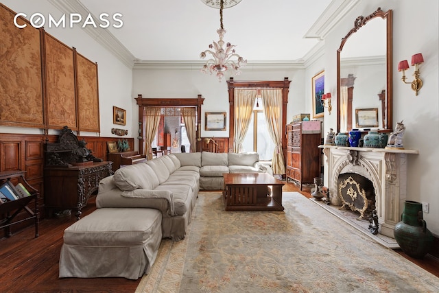 138 W 73rd St, New York City, NY 10023 - living room featuring a chandelier, ornamental molding, a fireplace, wainscoting, and wood finished floors