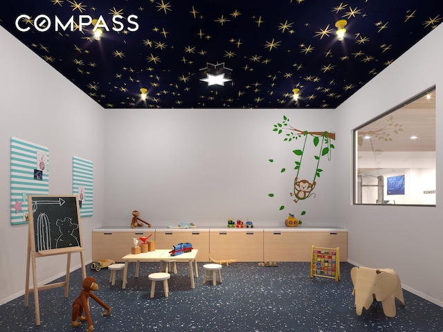 recreation room with carpet flooring and baseboards