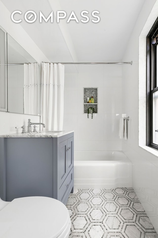 bathroom featuring shower / bath combination with curtain, vanity, and toilet