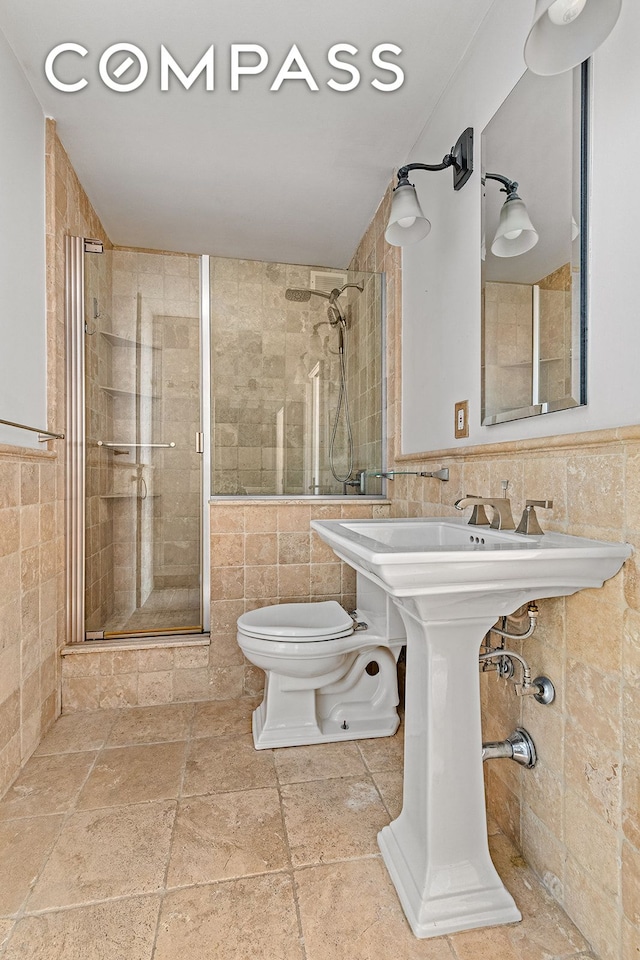 245 E 54th St Unit 25St, New York City, NY 10022 - bathroom with tile walls, toilet, and a shower stall