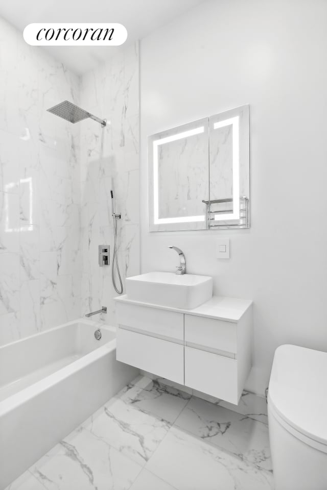 bathroom featuring toilet, shower / bathtub combination, vanity, and marble finish flooring