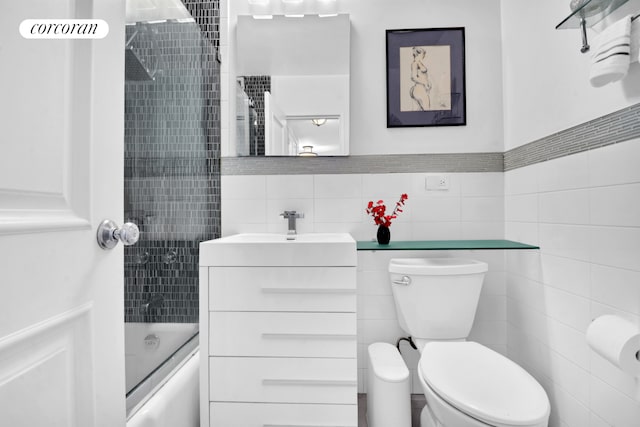 205 3rd Ave Unit 8K, New York City, NY 10003 - bathroom with tile walls, vanity,  shower combination, and toilet