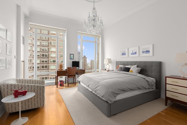 205 E 85th St Unit Ph2B, New York City, NY 10028 - bedroom with a chandelier, crown molding, wood finished floors, a desk, and access to exterior
