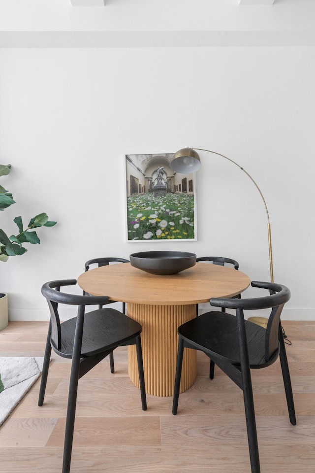 dining room with baseboards and light wood-style flooring
