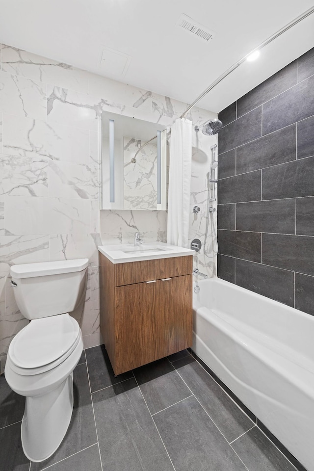 full bathroom with toilet, shower / bath combo, vanity, and tile walls