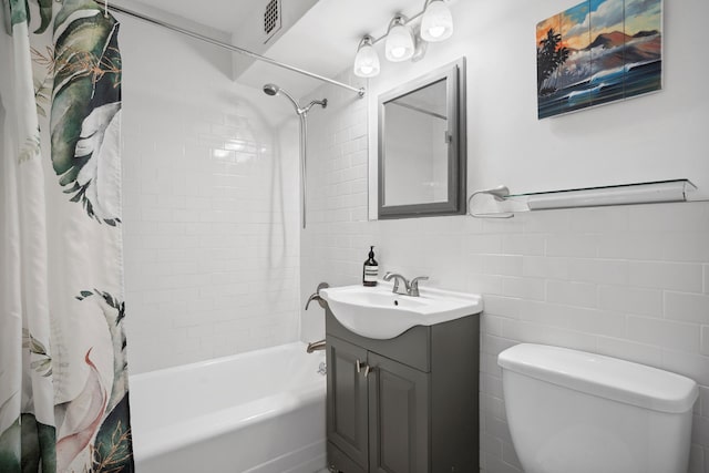 181 E 73rd St Unit 2B, New York City, NY 10021 - bathroom featuring tile walls, shower / tub combo with curtain, vanity, and toilet