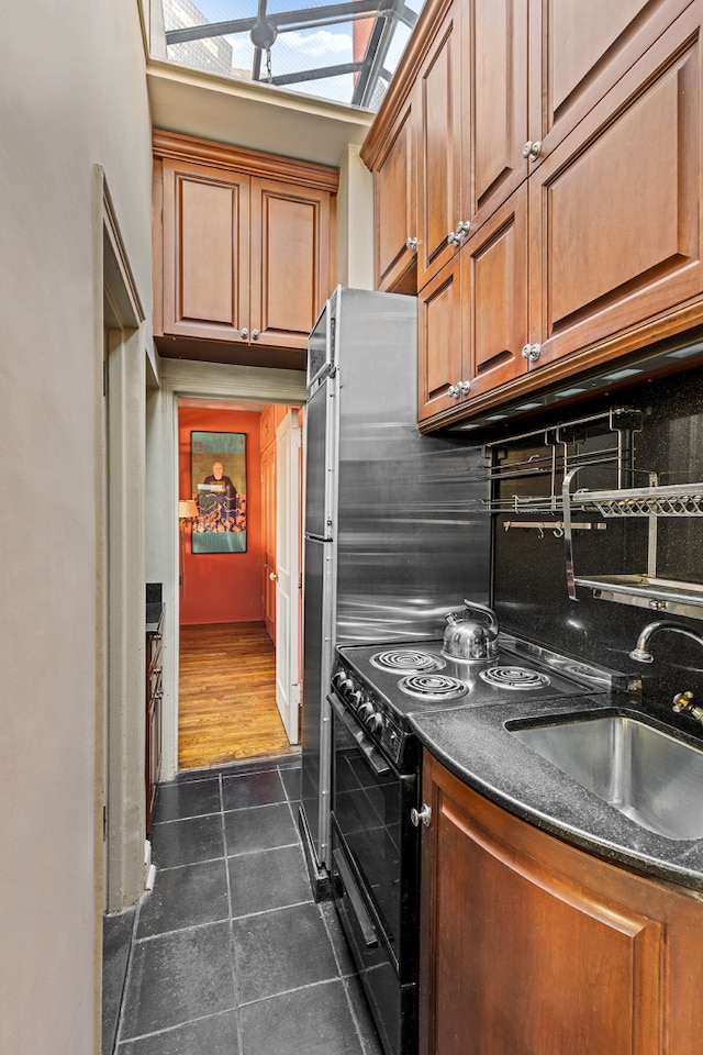 71 Park Ave Phb, Phb, New York City, NY 10016 - kitchen with dark tile patterned flooring, dark countertops, decorative backsplash, and brown cabinetry