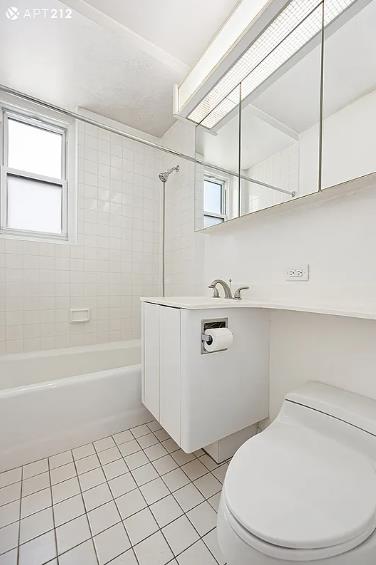 63 E 9th St Unit 7-T, New York City, NY 10003 - full bath with tile patterned flooring, washtub / shower combination, and vanity