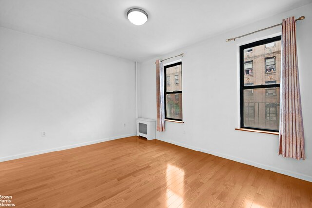 828 Gerard Ave Unit 2G, New York City, NY 10451 - unfurnished room featuring light wood-style flooring, plenty of natural light, and baseboards