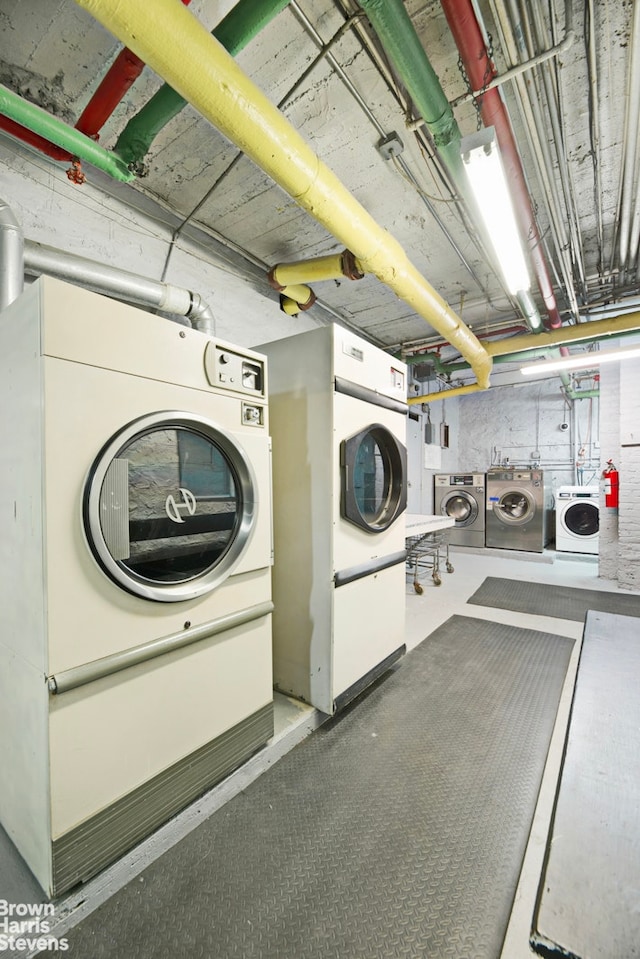 clothes washing area with washer and dryer