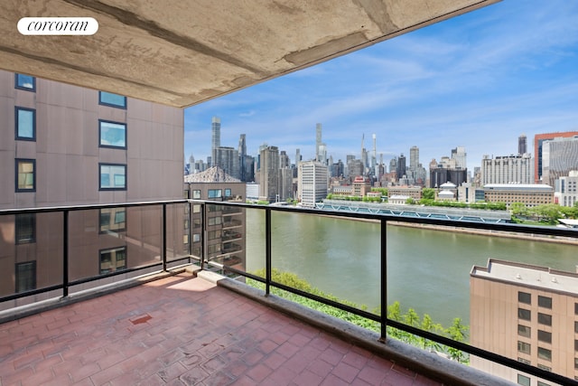 balcony with a skyline view and a water view