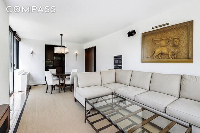 343 E 74th St Unit 15D, New York City, NY 10021 - living area featuring light wood finished floors