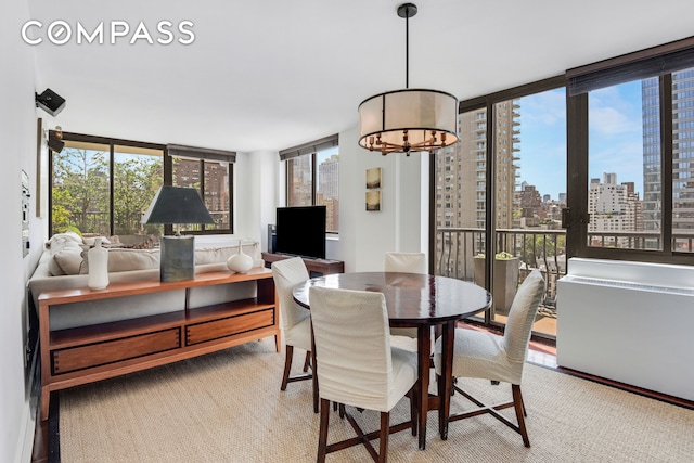343 E 74th St Unit 15D, New York City, NY 10021 - dining space with a chandelier and light colored carpet