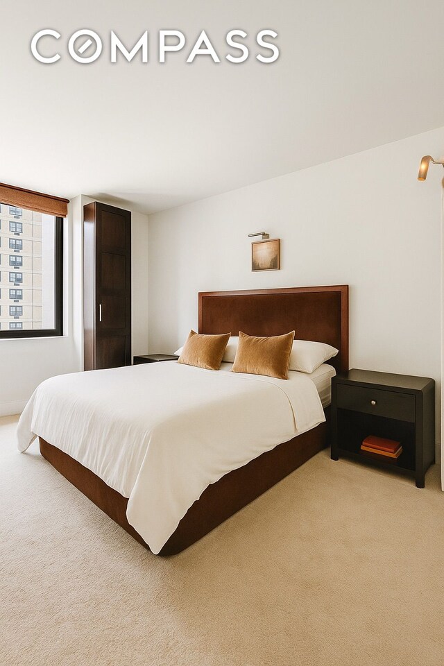343 E 74th St Unit 15D, New York City, NY 10021 - bedroom with light colored carpet