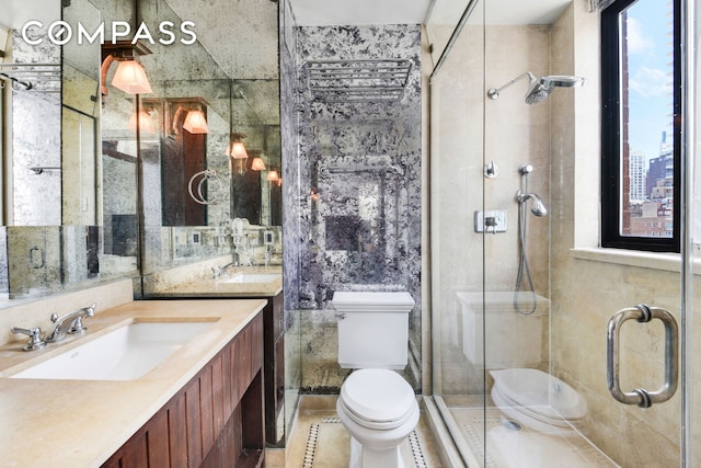 343 E 74th St Unit 15D, New York City, NY 10021 - bathroom with toilet, vanity, a shower stall, and tile patterned floors