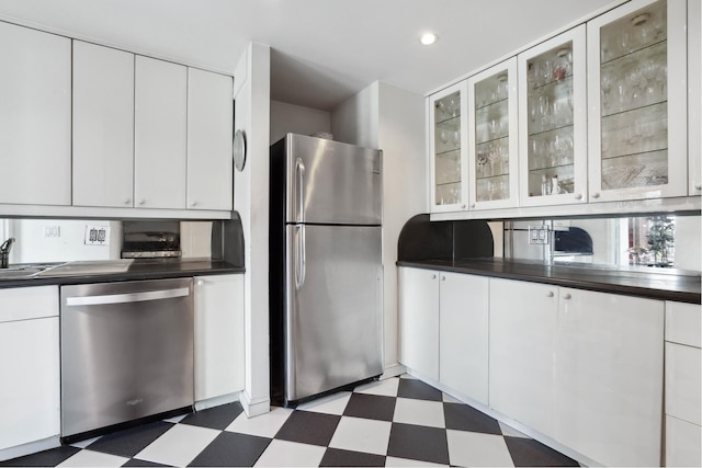 33 E End Ave Unit 2B, New York City, NY 10028 - kitchen with stainless steel appliances, tile patterned floors, dark countertops, and recessed lighting