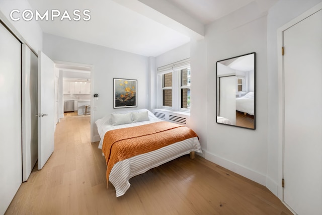 bedroom featuring light wood-style flooring and baseboards