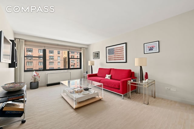 1065 Park Ave Unit 11A, New York City, NY 10128 - carpeted living room featuring baseboards