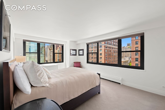 1065 Park Ave Unit 11A, New York City, NY 10128 - bedroom with carpet flooring, a baseboard heating unit, and radiator
