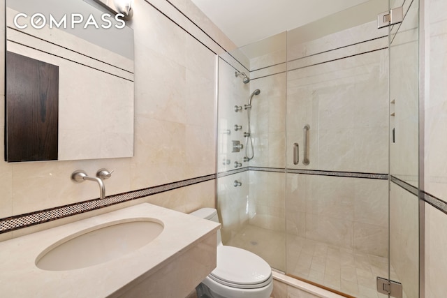 1065 Park Ave Unit 11A, New York City, NY 10128 - full bathroom with toilet, a stall shower, tile walls, and a sink