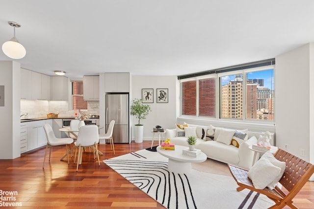 206 E 95th St Unit 12B, New York City, NY 10128 - living room featuring wood finished floors