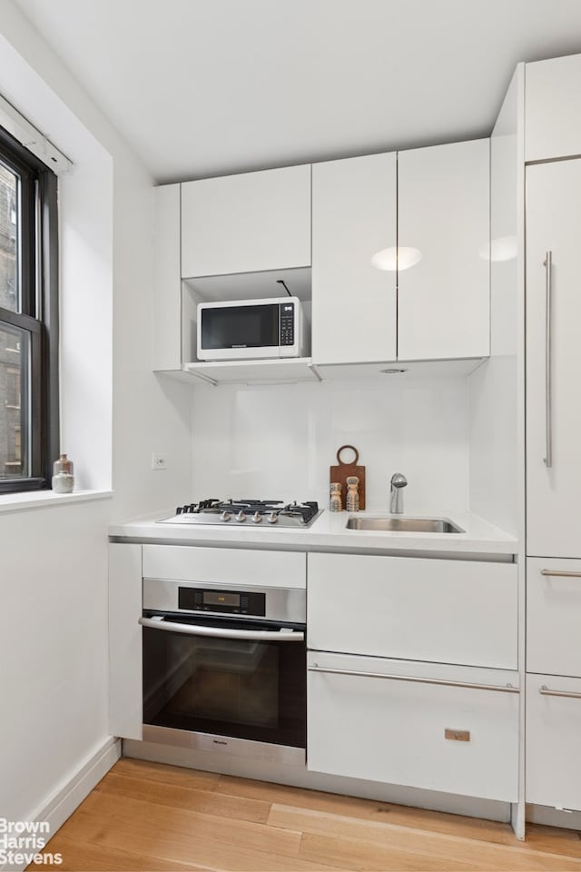 230 Riverside Dr Unit 3K, New York City, NY 10025 - kitchen with appliances with stainless steel finishes, white cabinets, modern cabinets, and light countertops