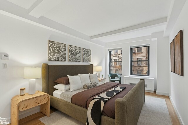 230 Riverside Dr Unit 3K, New York City, NY 10025 - bedroom featuring light wood-style floors and beam ceiling