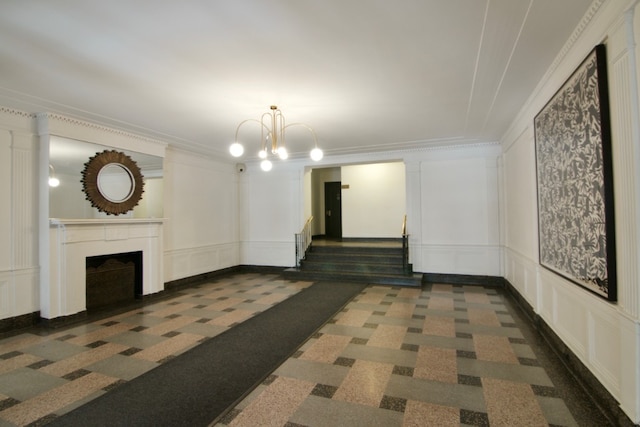 811 Cortelyou Rd Unit 2O, New York City, NY 11218 - unfurnished living room with a decorative wall, a chandelier, a fireplace, carpet, and ornamental molding