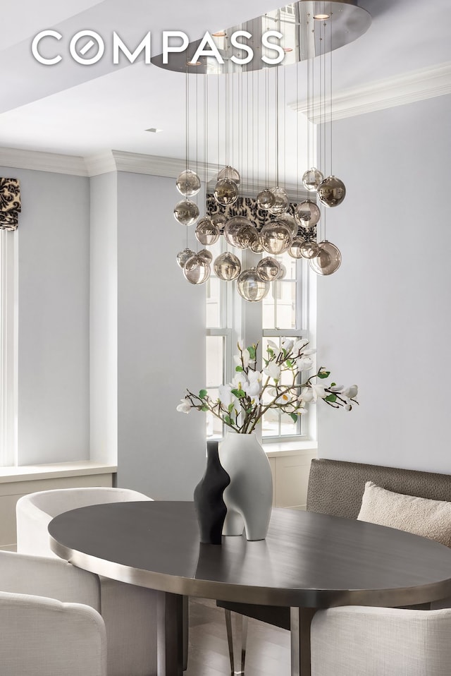 40 E 66th St Unit 12B, New York City, NY 10065 - dining room featuring a chandelier and crown molding