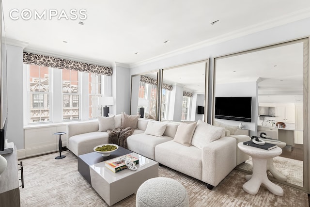 40 E 66th St Unit 12B, New York City, NY 10065 - living room with plenty of natural light, ornamental molding, and light wood-style floors