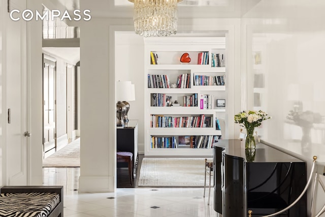 40 E 66th St Unit 12B, New York City, NY 10065 - living area featuring a chandelier, tile patterned floors, and built in features