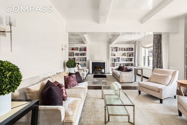 40 E 66th St Unit 12B, New York City, NY 10065 - living room with crown molding, a lit fireplace, built in shelves, and beam ceiling