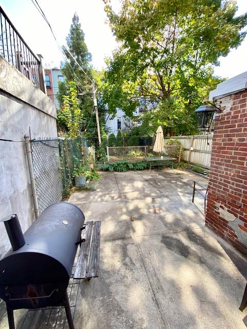 188 Mac Donough St, New York City, NY 11216 - fenced backyard featuring a patio and a grill