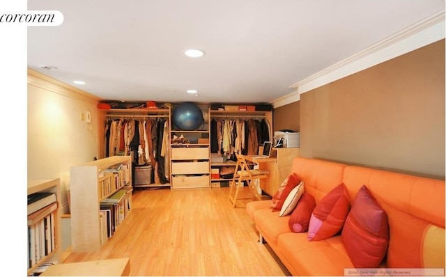 living area featuring crown molding, wood finished floors, and recessed lighting