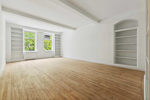 410 W 24th St Unit 4L, New York City, NY 10011 - unfurnished room with built in shelves, wood-type flooring, beam ceiling, and baseboards