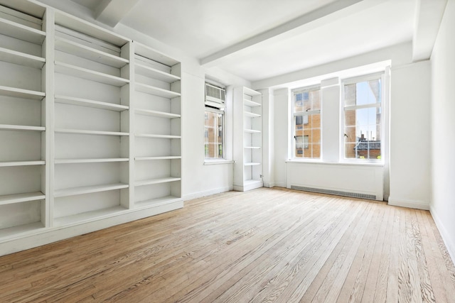 unfurnished room featuring hardwood / wood-style flooring and baseboards