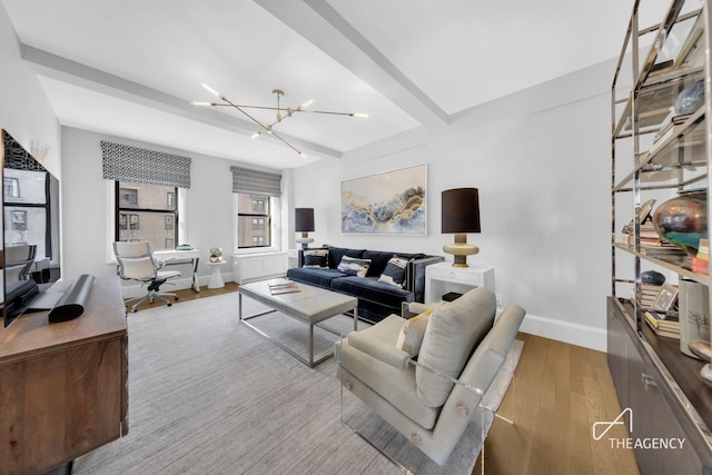living room featuring a desk, a chandelier, wood finished floors, and baseboards