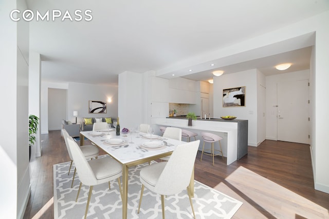 dining area with wood finished floors and baseboards