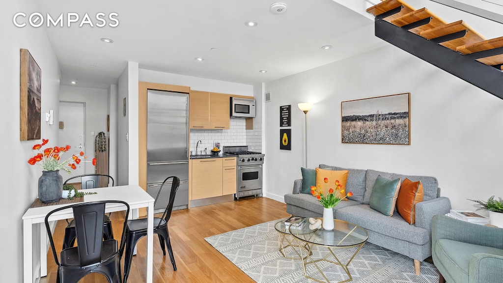 215 E 81st St Unit 7E, New York City, NY 10028 - living room with light wood-style floors and recessed lighting