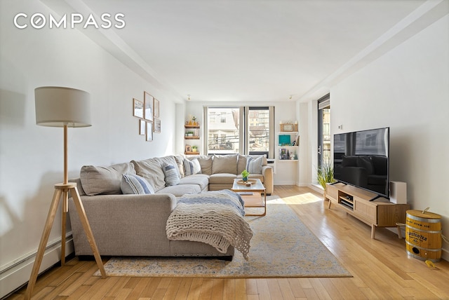 91-16 Shore Front Pkwy Unit 2F, New York City, NY 11693 - living area with a baseboard heating unit and hardwood / wood-style flooring
