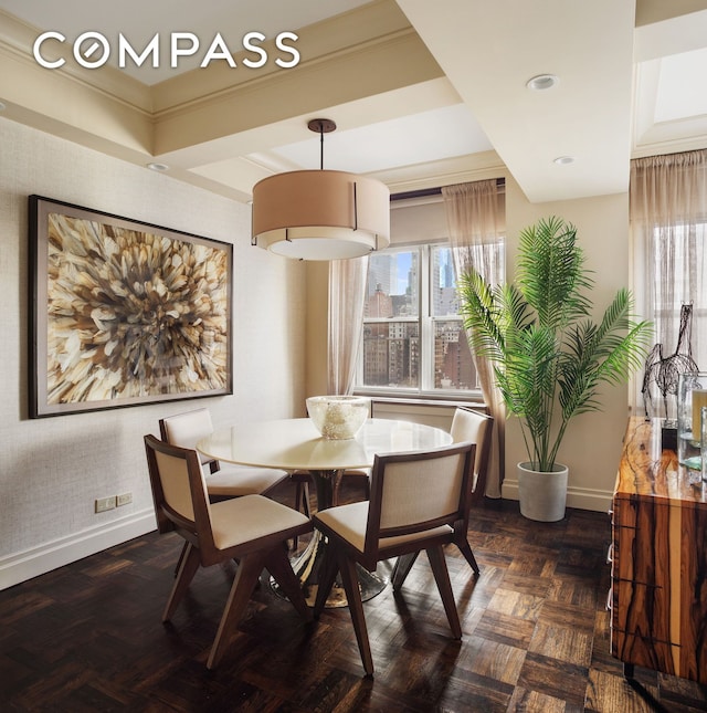 dining room with baseboards, healthy amount of natural light, and ornamental molding