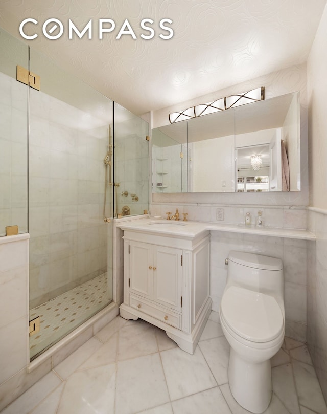 full bathroom with a stall shower, toilet, tile patterned flooring, and vanity