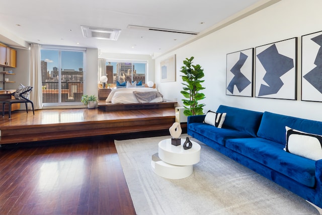 living area with wood-type flooring and a view of city