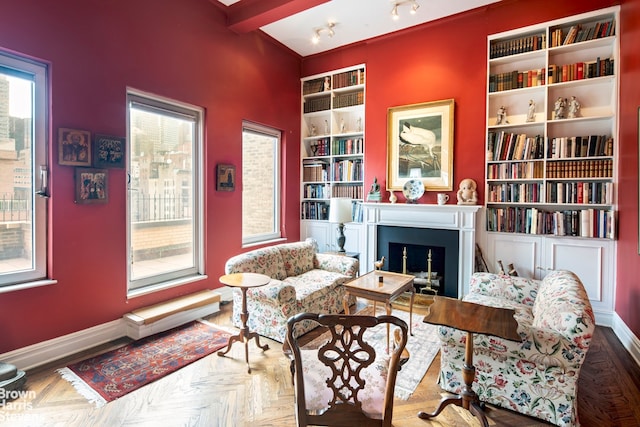 136 E 64th St Phc, Phc, New York City, NY 10065 - living area featuring a fireplace, built in shelves, and baseboards